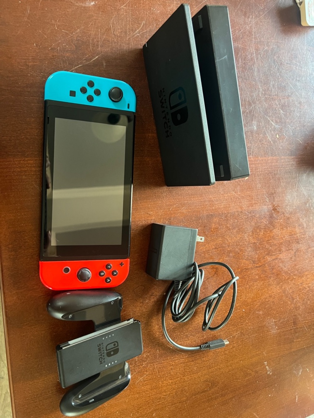 Nintendo switch with Blue and Red Joy-Con with controller, charger and console.